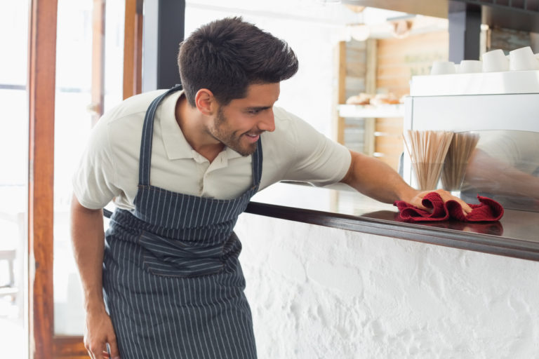 waiter wiping down surface