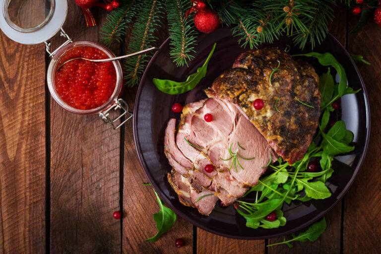 Christmas baked ham and red caviar, served on the old wooden table. Flat lay. Top view